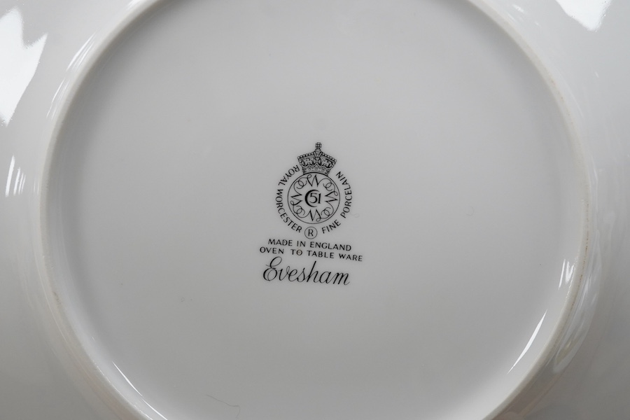 A Royal Worcester Evesham pattern dinnerware to include dinner plates, soup bowls and ramekins, largest 25cm in diameter. Condition - mostly good